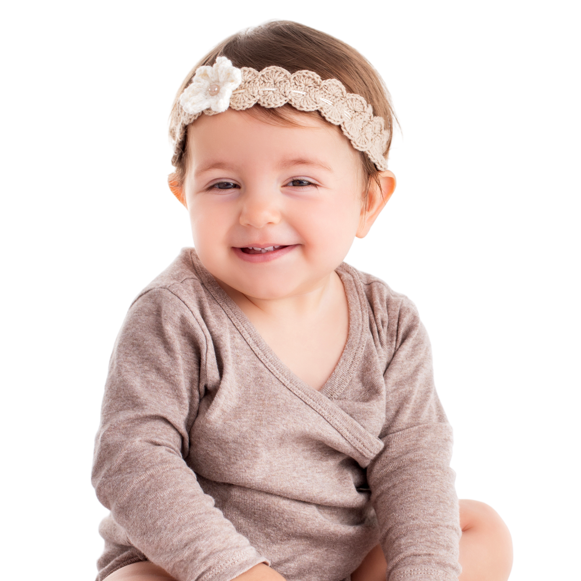 Smiling toddler girl with a knitted headband with a flower
